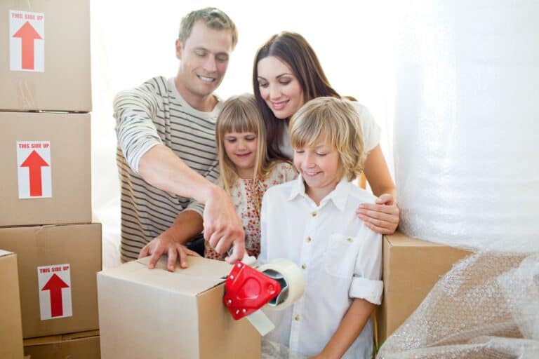 A happy family packing boxes for the house move