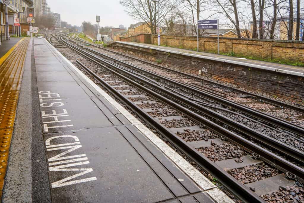 The rail tracks of Lewisham Station on a rainy day