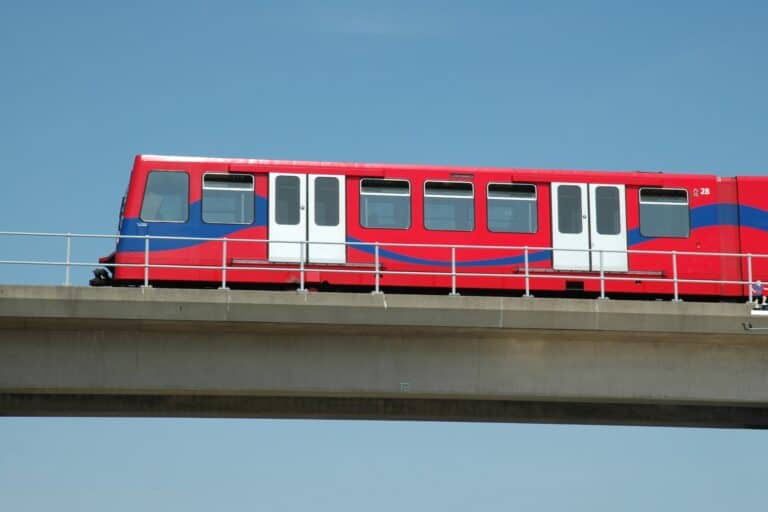 A moving Docklands Light Railway train in the concept of 'how to use Lewisham's public transport'.