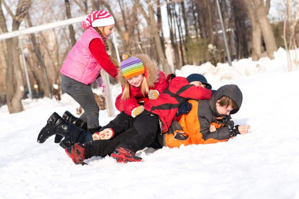 Children playing in a snowy park